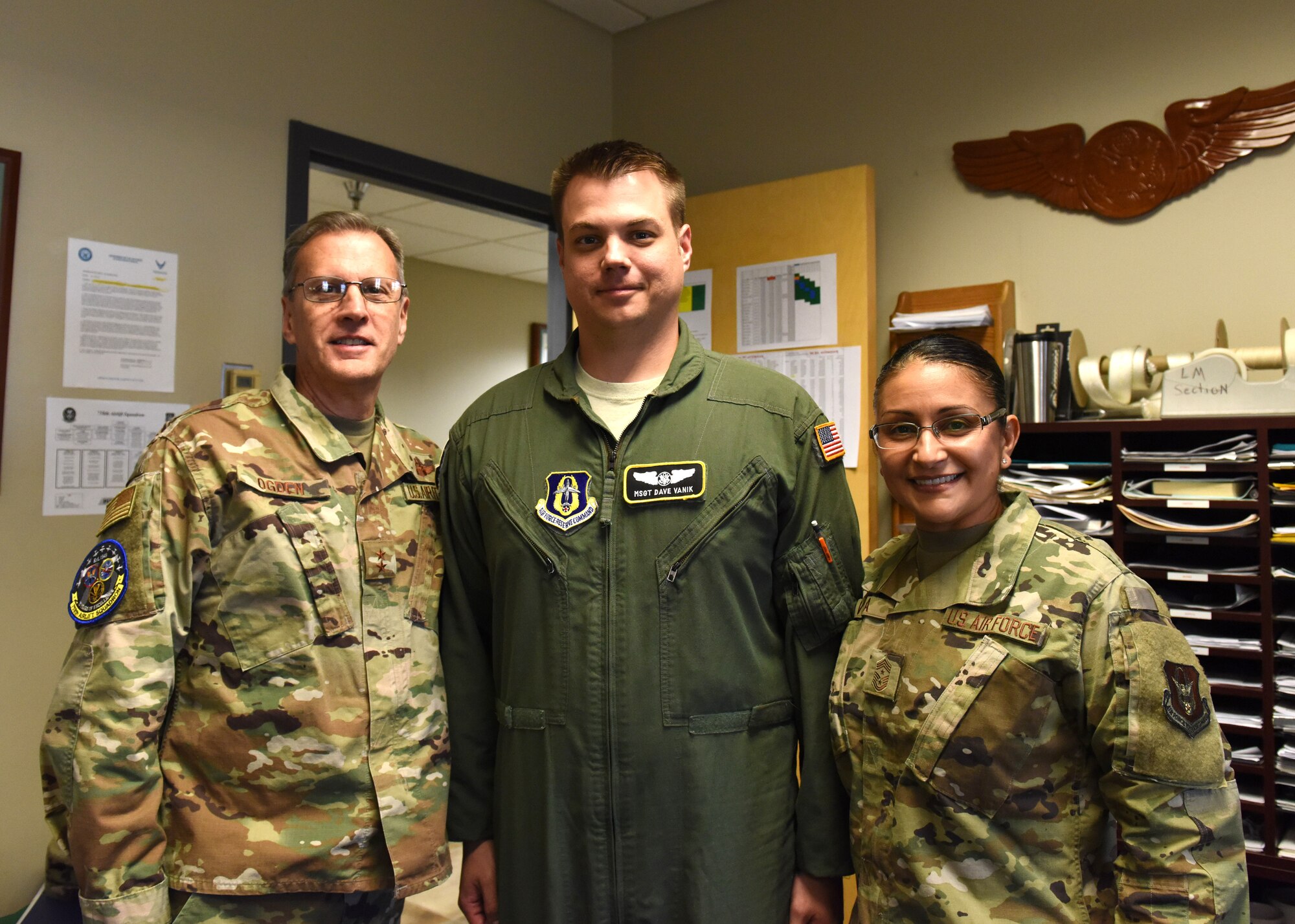 Master Sgt. Dave Vanik, 758th Airlift Squadron loadmaster, poses for a photo with Maj. Gen. Randall A. Ogden, 4th Air Force commander, and Chief Master Sgt. Cynthia Villa, 4th AF command chief, after receiving a challenge coin at the Pittsburgh International Airport Air Reserve Station, Pennsylvania, Nov. 3, 2019.