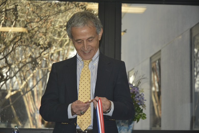 Dr. Zeki Demirbilek, a research hydraulics engineer with the Coastal and Hydraulics Laboratory at the U.S. Army Engineer Research and Development Center, received a giant penny during his retirement ceremony held at the ERDC-Vicksburg main campus, Nov. 15, 2019. Demirbilek is known for handing out pennies to co-workers for accomplishing good works. (U.S. Army photo by Carol C. Coleman)