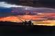 An MQ-9 Reaper sits on the flight line underneath a Nevada sunset.