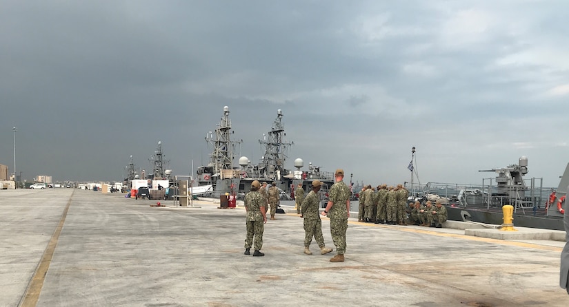 Sailors look at approaching storm.