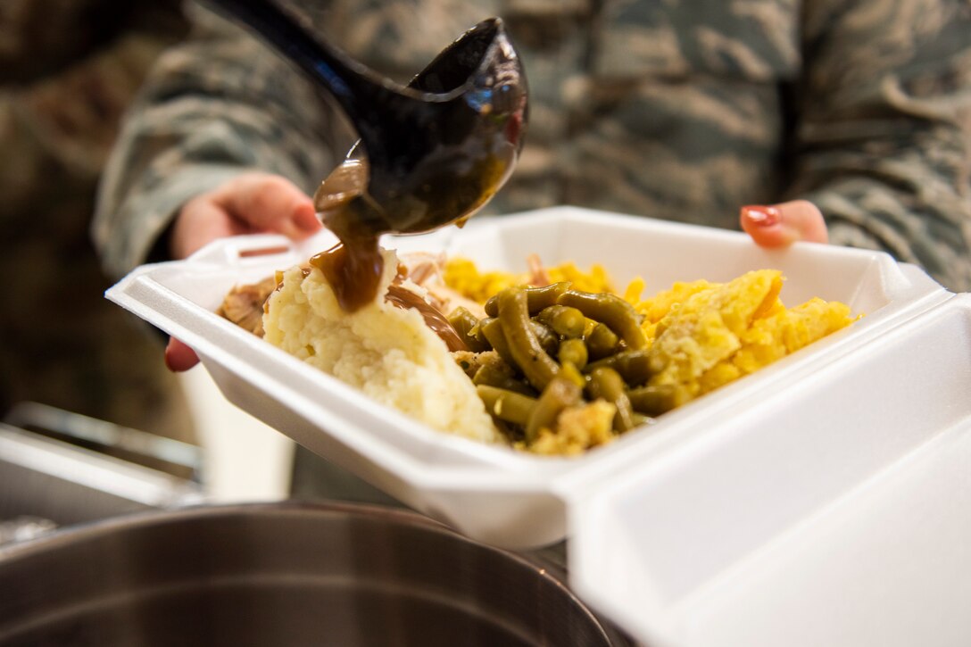 A photo of an Airman receiving food during the Annual Airman Thanksgiving Lunch