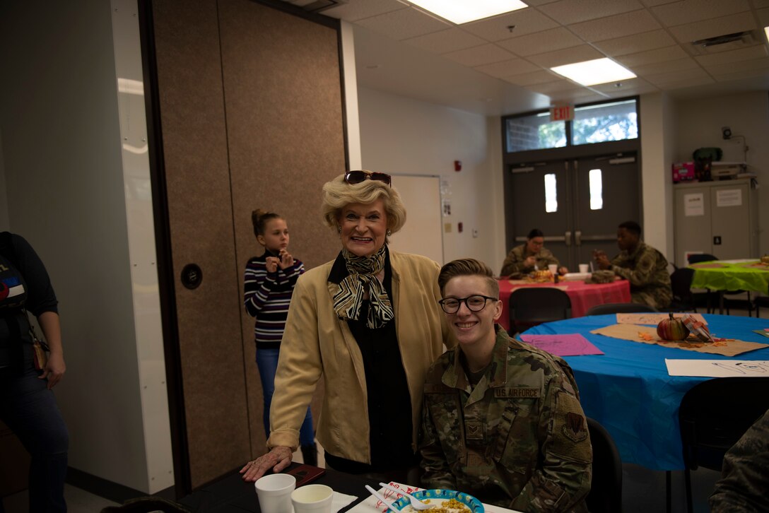 A photo of an Airman posing with Dr. Lucy Greene during the Annual Airman Thanksgiving Lunch