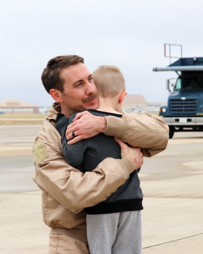Maj. Thomas Bryceland, a KC-135R Stratotanker pilot with the 465th Air Refueling Squadron, hugs his son upon returning home from a deployment to Southwest Asia Nov. 22, 2019, at Tinker Air Force Base, Oklahoma. (U.S. Air Force photo by Senior Airman Mary Begy)