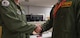 Capt. Kendall Smith (left), 20th Bomb Squadron assistant director of operations, and Lt. Col. John Burrell (right), 23rd Bomb Squadron commander, shake hands after training together at Barksdale Air Force Base, La., Nov. 21, 2019.