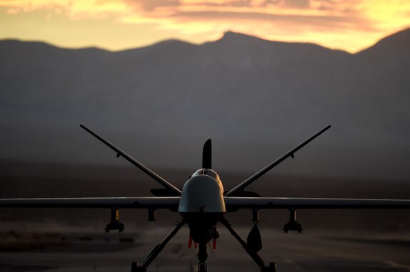 An MQ-9 Reaper sits on the flight line underneath a Nevada sunset.