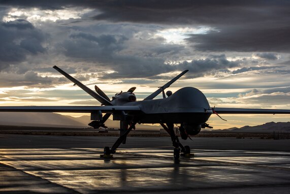 An MQ-9 Reaper sits on the flight line underneath a Nevada sunset.
