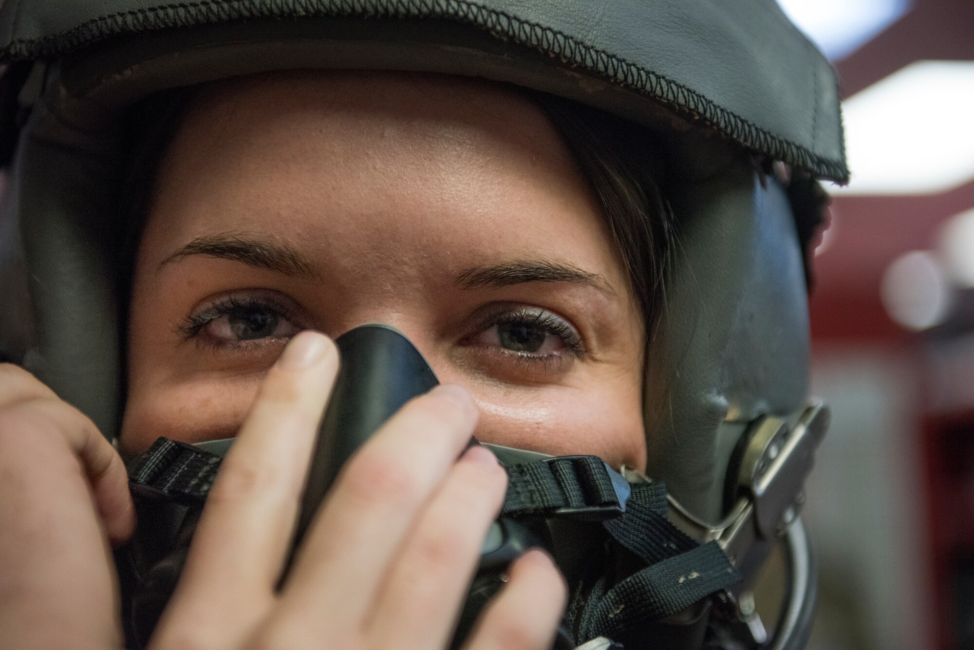 Duke University Hacking for Defense (H4D) student Joy Duer tightens her flight helmet during a pre-flight inspection with the 4th Equipment Maintenance Squadron aircraft flight equipment personnel during a tour, Nov. 15, 2019, Seymour Johnson Air Force Base, N.C. During the culmination period of their semester project, the senior received an F-15E Strike Eagle flight. The H4D class assignment consisted of Duke University seniors finding a solution to a real world command and control problem. (U.S. Air Force photo by Tech. Sgt. Vernon Young Jr.)