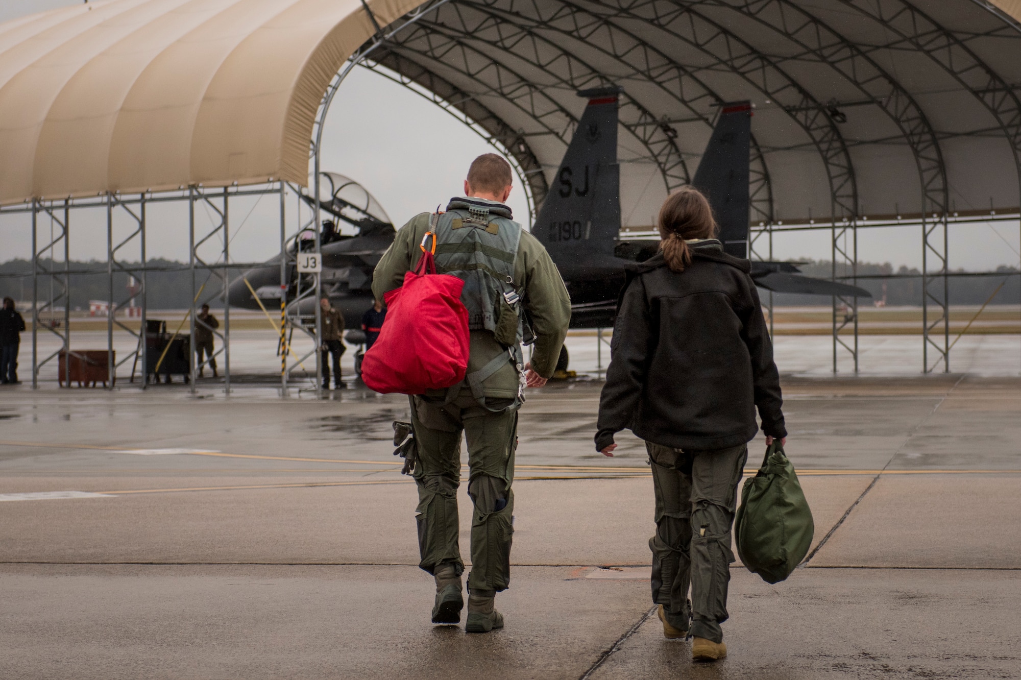 Lt. Col. Boar, 334th Fighter Squadron, director of operation, steps to an F-15E Strike Eagle alongside Duke University Hacking for Defense (H4D) student Joy Duer prior to a flight, Nov. 15, 2019, Seymour Johnson Air Force Base, N.C. During the culmination period of their semester project, the senior received an F-15E Strike Eagle flight. The H4D class assignment consisted of Duke University seniors finding a solution to a real-world command and control problem. (U.S. Air Force photo by Tech. Sgt. Vernon Young Jr.)