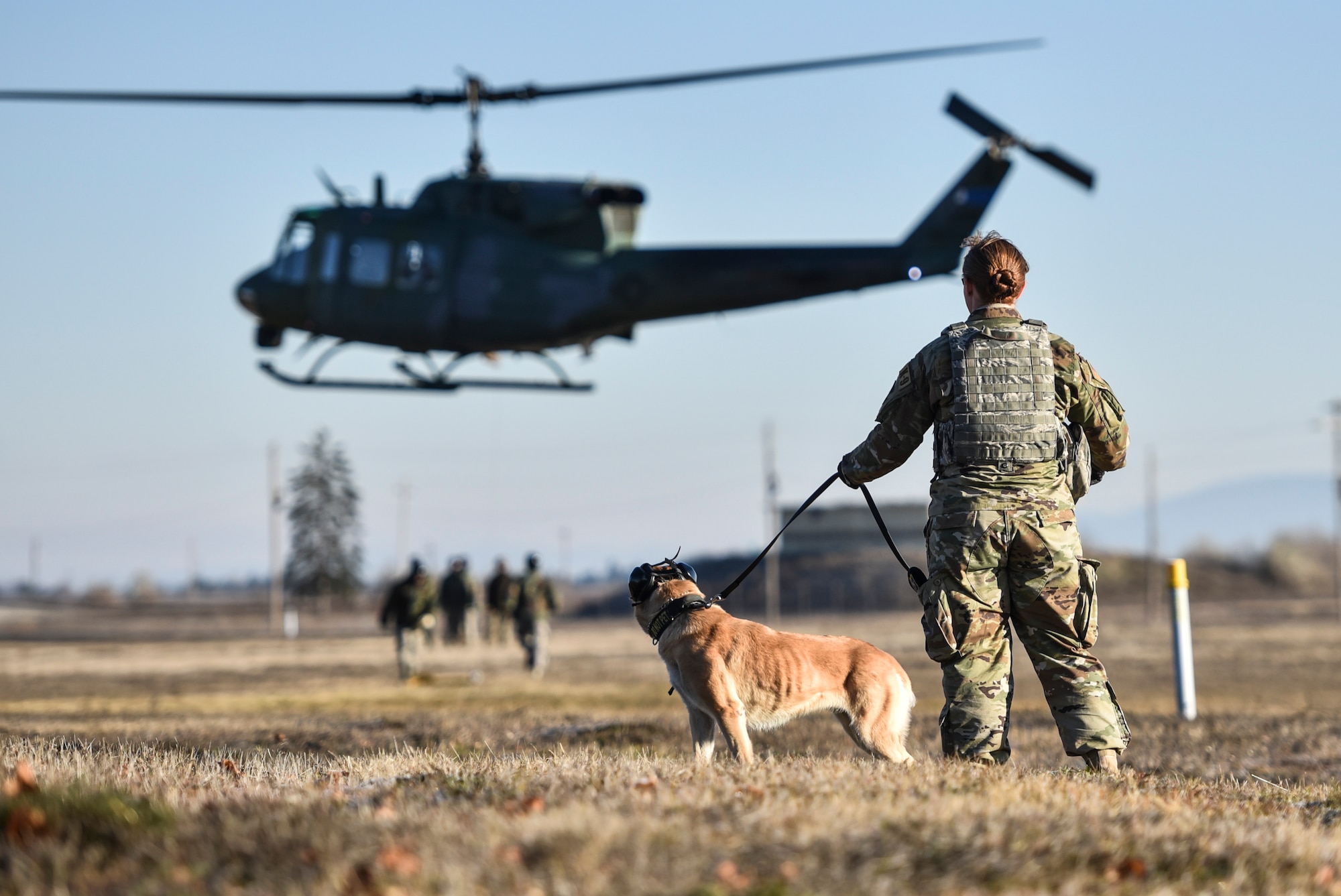 U.S. Air Force Senior Airman Bethany Ray, 92nd Security Forces Squadron Military Working Dog handler, and her dog Lili prepare for UH-1N Huey training Nov. 21, 2019, at Fairchild Air Force Base, Washington.