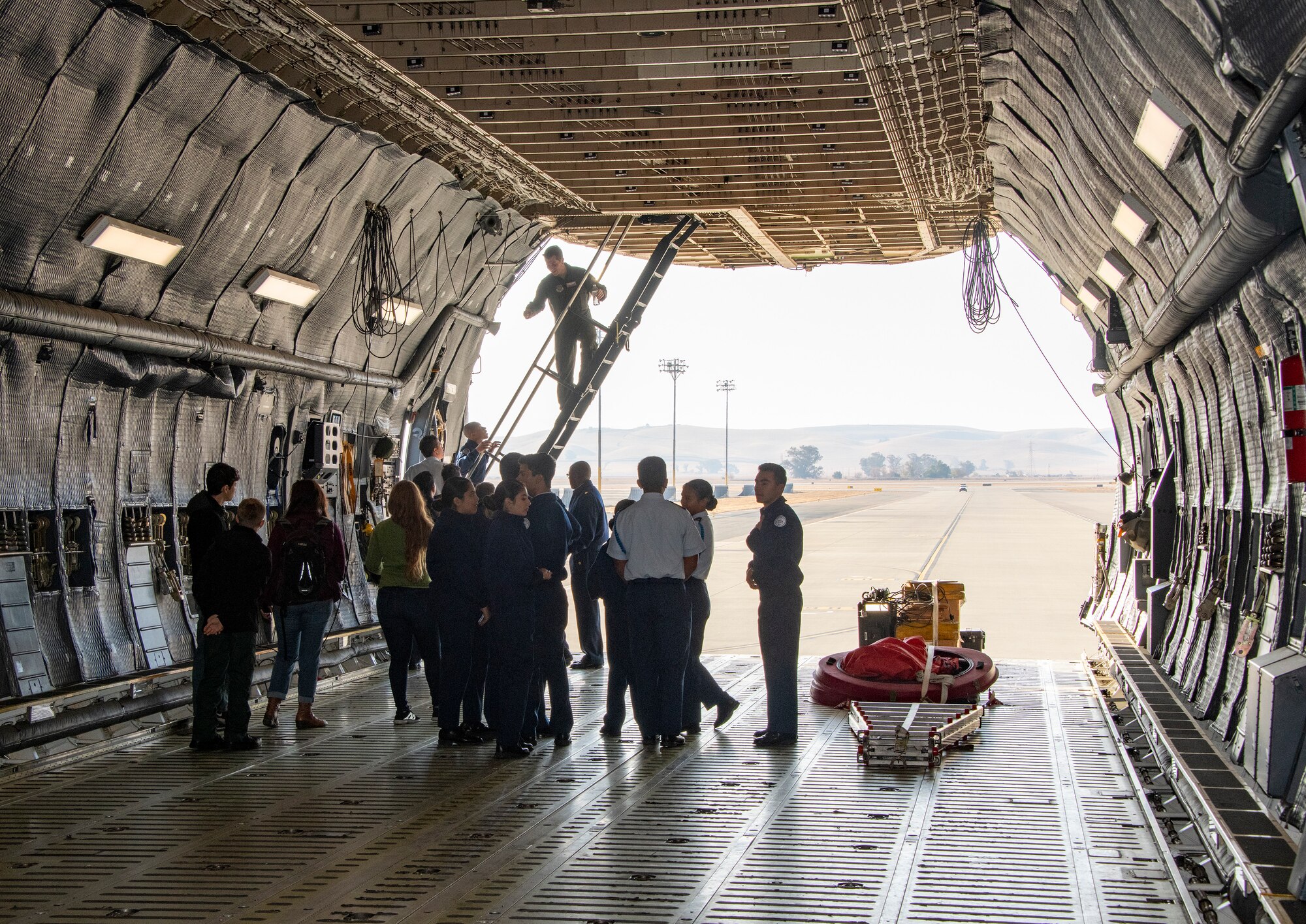 Students gain firsthand experience during a tour of a C-5 Super Galaxy during a base tour Nov. 21, 2019, at Travis Air Force Base, California. Travis AFB hosted Junior Reserve Officer Training Corps students from five Northern California high schools and one Oregon high school. The students learned about various U.S. Air Force career fields and toured static aircraft, the Heritage Center museum and dormitories. They also talked with Airmen about military life. (U.S. Air Force photo by Heide Couch)