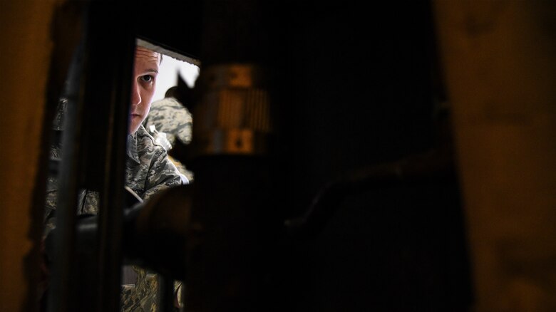 a photo of an Airman seting up a water fountain.