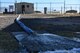 Water drains out of a pipe.