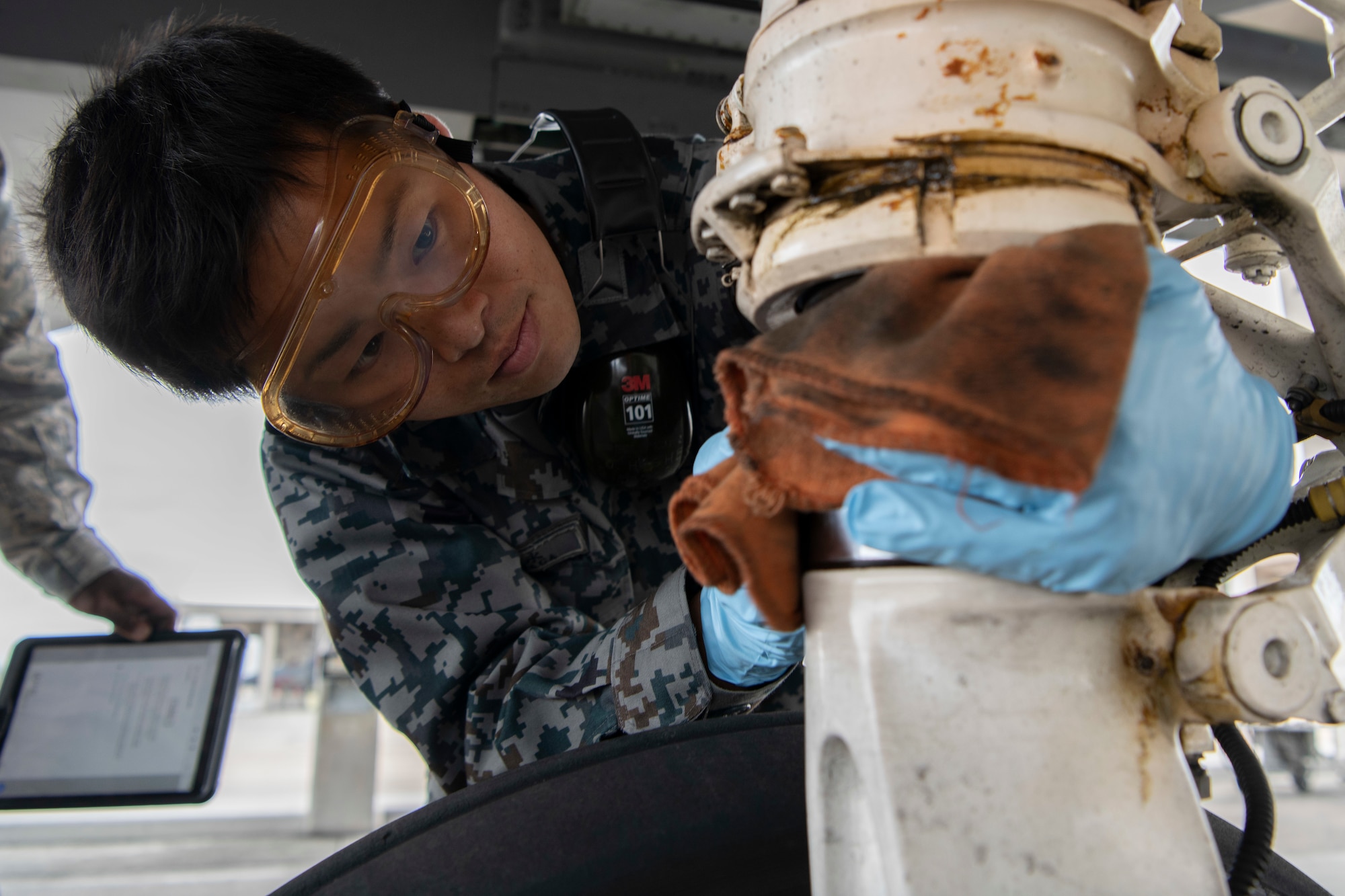 Japanese Self-Defense Force Staff Sgt. Shuichiro Masunaga, 6th Tactical Fighter Squadron aircraft general technician, performs thru-flight maintenance on an F-15C Eagle as part of an NCO Bilateral Exchange program Nov.19, 2019, at Kadena Air Base, Japan. Bilateral exchanges allow for a better understanding of the capabilities held by each countries Armed Forces, as well as the opportunity to improve relations between the United States and Japan. (U.S.Air Force photo by Senior Airman Rhett Isbell)