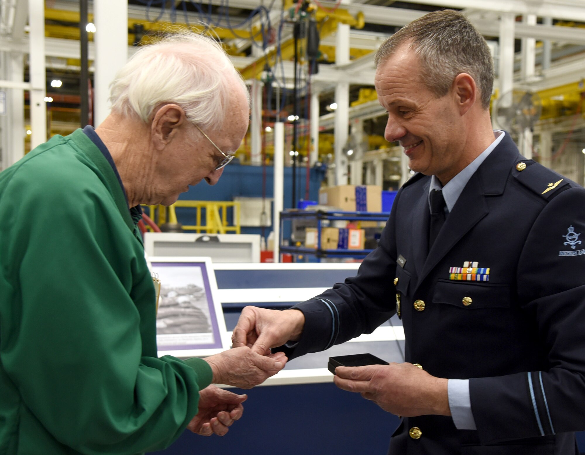 An image of Dwight Journey receiving his brother's dog tags from Royal Netherlands Air Force 1st Lt. Willem van der Steen