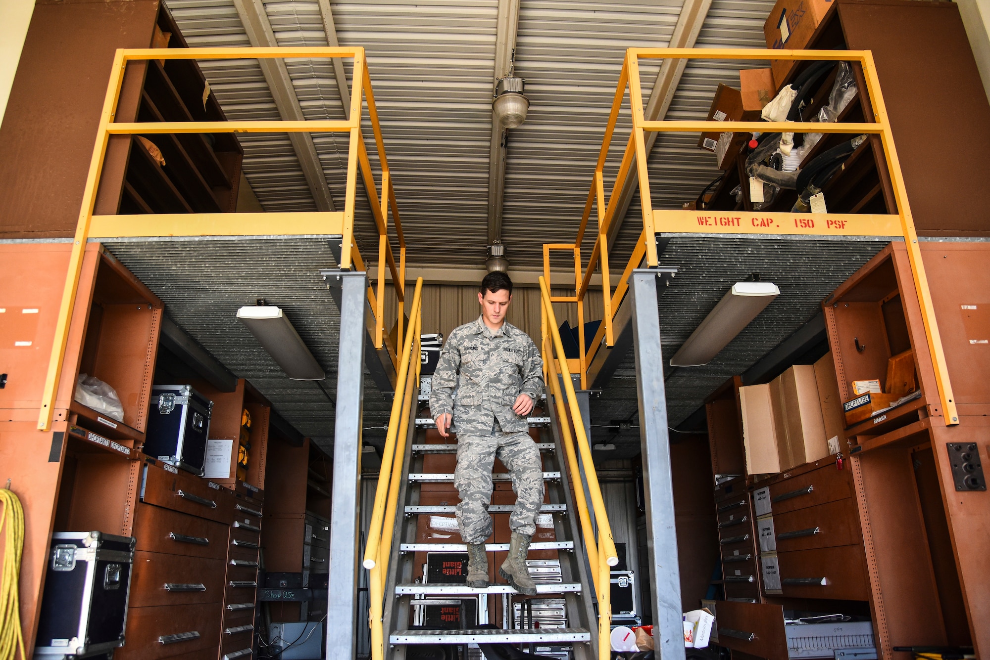 An Airman walks down the stairs.