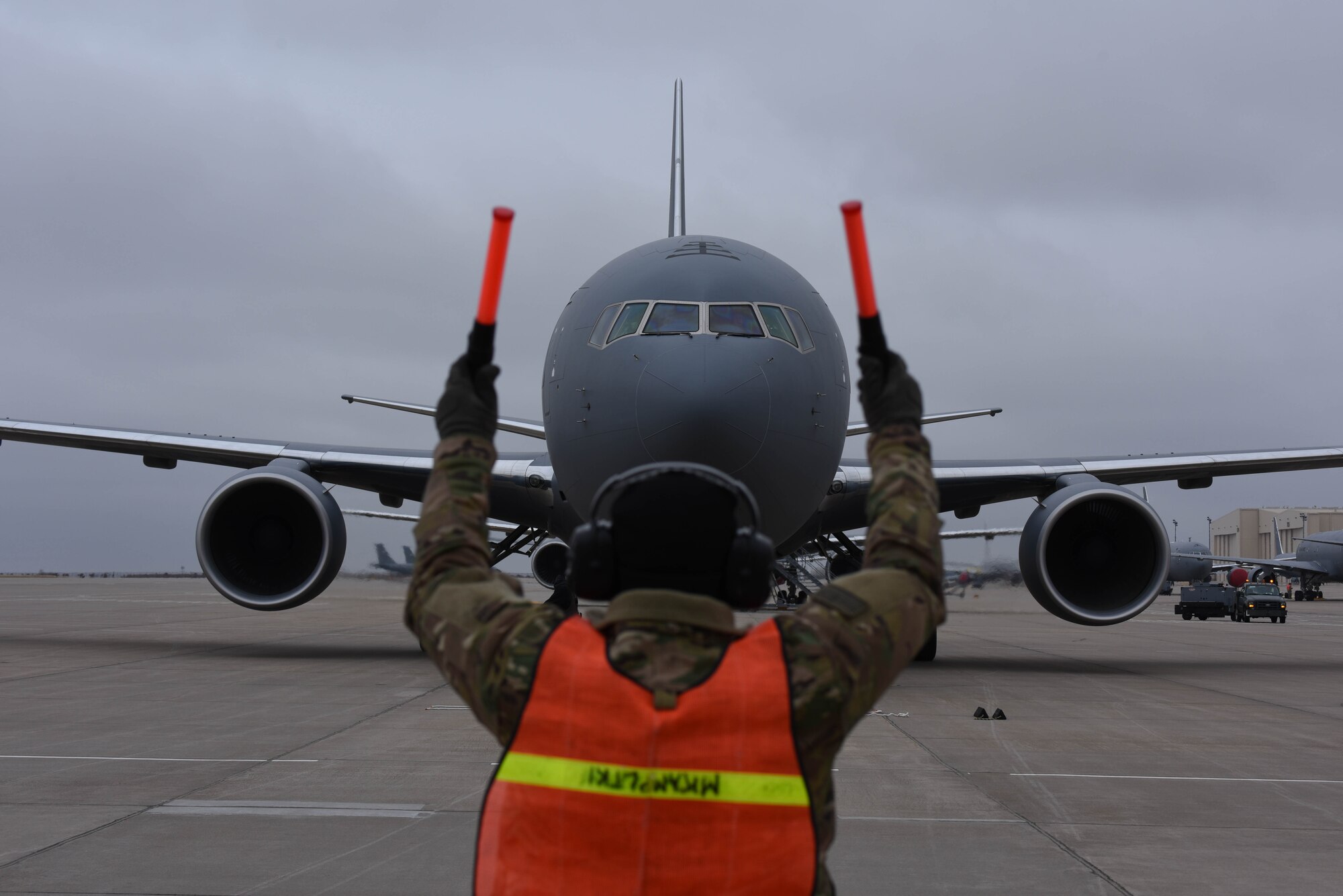 A 22nd Maintenance Group crew chief marshals in McConnell’s 19th KC-46 Pegasus Nov. 22, 2019, at McConnell Air Force Base, Kan. McConnell will have a fleet of 36 KC-46s to lead the future of aerial refueling. (U.S. Air Force photo by Airman 1st Class Marc Garcia)