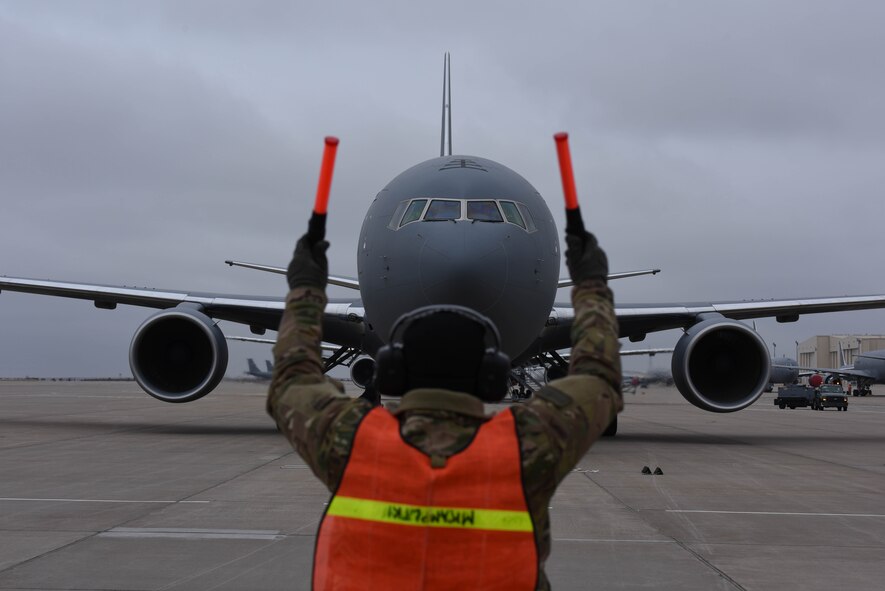 A 22nd Maintenance Group crew chief marshals in McConnell’s 19th KC-46 Pegasus Nov. 22, 2019, at McConnell Air Force Base, Kan. McConnell will have a fleet of 36 KC-46s to lead the future of aerial refueling. (U.S. Air Force photo by Airman 1st Class Marc Garcia)
