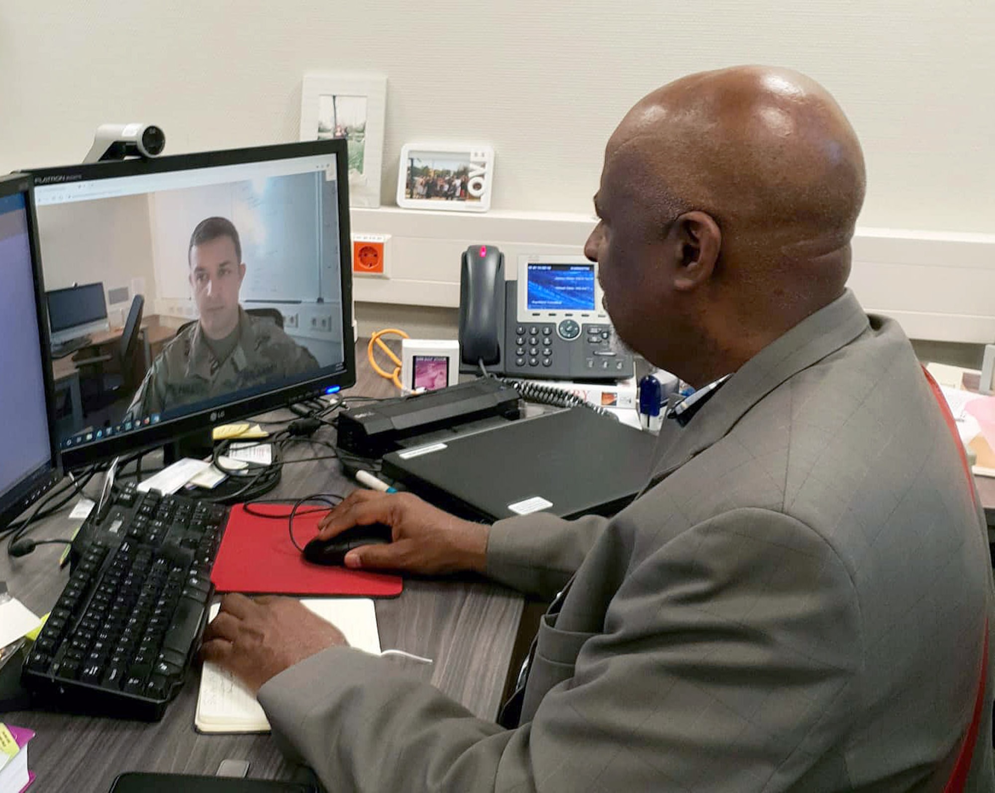 James White, a Health System Specialist with Regional Health Command Europe, uses video conferencing to discuss periodic health assessments with Sgt. 1st Class Todd Hall, the noncomssioned officer in charge of Virtual Health Europe. (Courtesy photo)