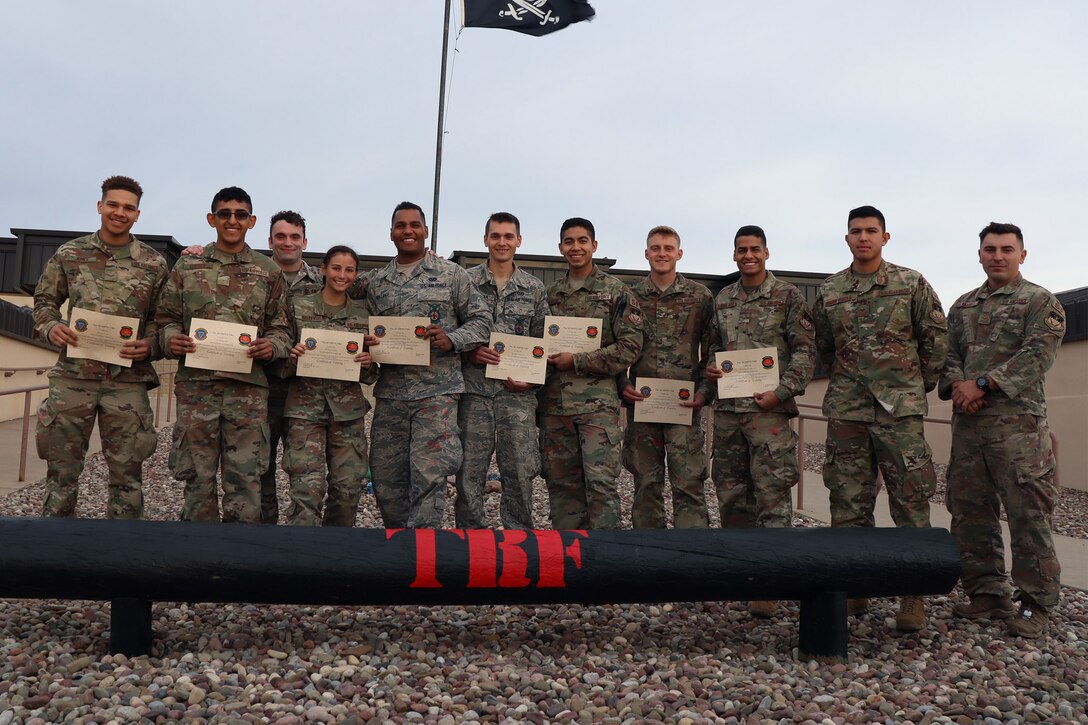 Senior Airman Adam Van Lange and Staff Sgt. Joshua Sweetman, 341st Civil Engineer Squadron firefighters, center, pose with security forces peers with certification under the base Tactical Response Force Oct. 25, 2019, at Malmstrom Air Force Base, Mont.