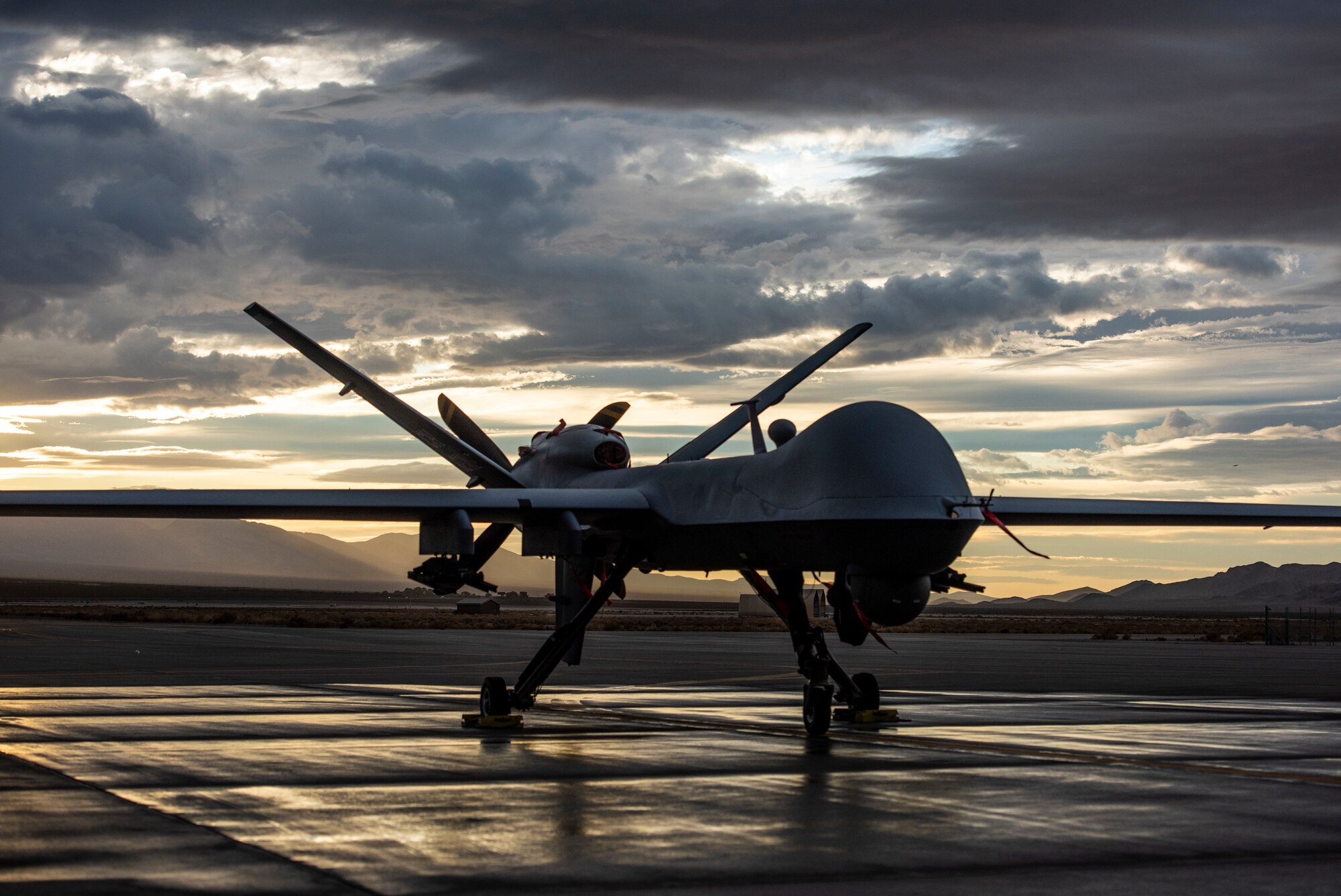 An MQ-9 Reaper sits on the flight line underneath a Nevada sunset.