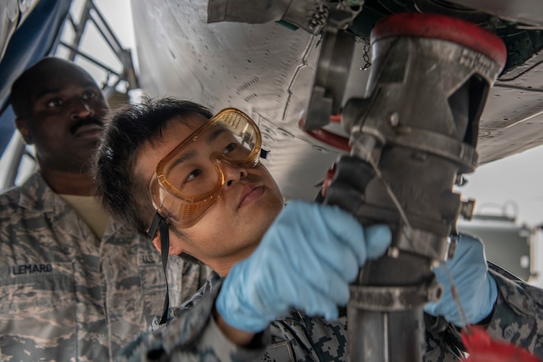 Japanese Self-Defense Force Staff Sgt. Shuichiro Masunaga, 6th Tactical Fighter Squadron aircraft general technician, right, trains on refueling an F-15C Eagle with guidance from, U.S. Air Force Tech. Sgt. Adrian Lemard,18th Aircraft Maintenance Squadron crew chief, left, as part of an NCO Bilateral Exchange program Nov. 19, 2019, at Kadena Air Base, Japan. Bilateral exchanges allow for a better understanding of the capabilities held by each countries Armed Forces, as well as the opportunity to improve relations between the United States and Japan. (U.S. Air Force photo by Senior Airman RhettI sbell)