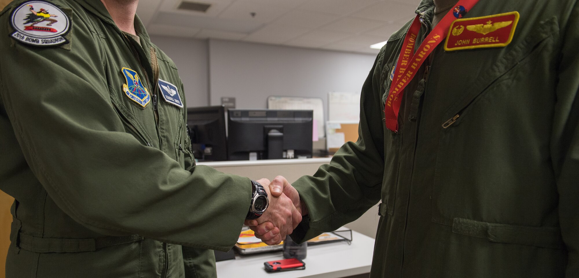 Capt. Kendall Smith (left), 20th Bomb Squadron assistant director of operations, and Lt. Col. John Burrell (right), 23rd Bomb Squadron commander, shake hands after training together at Barksdale Air Force Base, La., Nov. 21, 2019.