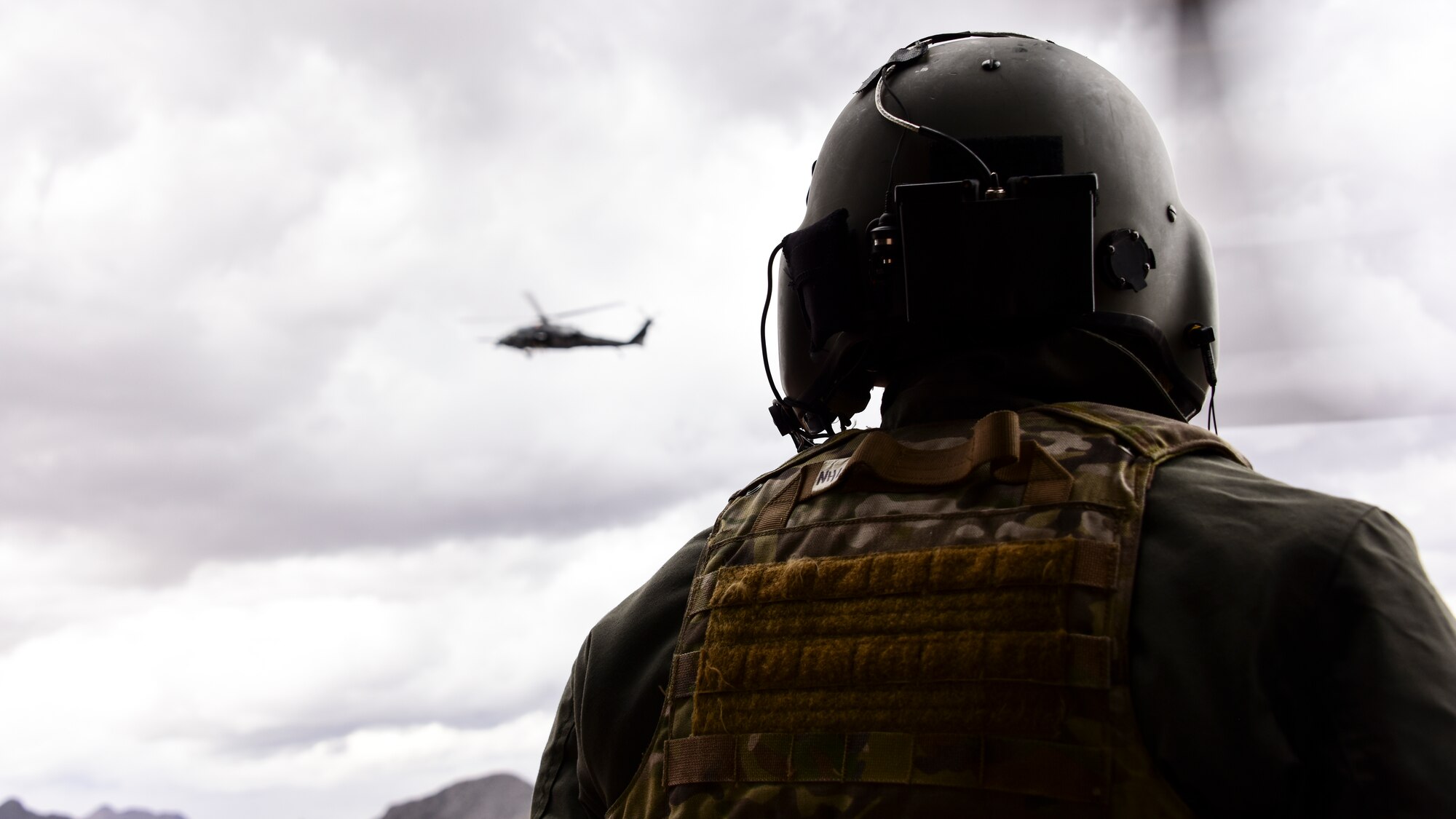 Airmen watches a helicopter fly