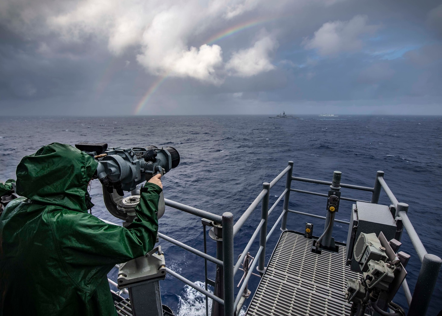 PHILIPPINE SEA (Nov. 21, 2019) Lt. j.g. Katherine Lindman, from Minneapolis, looks through binoculars on the bridge of the Ticonderoga-class guided-missile cruiser USS Chancellorsville (CG 62) during a group maneuvering exercise with ships from the Royal Australian Navy, Royal Canadian Navy, and Republic of Korea Navy as part of Pacific Vanguard 2019. Chancellorsville is forward-deployed to the U.S. 7th Fleet area of operations in support of security and stability in the Indo-Pacific region.