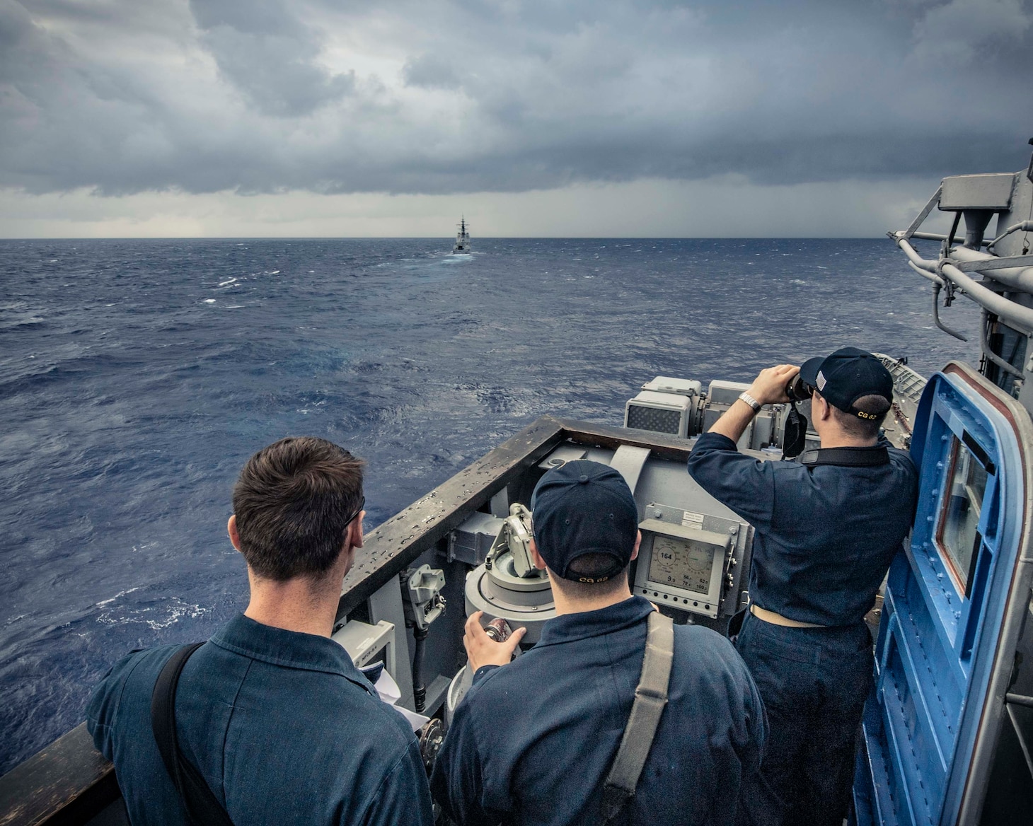 PHILIPPINE SEA (Nov. 21, 2019) Sailors stand watch on the bridge of the Ticonderoga-class guided-missile cruiser USS Chancellorsville (CG 62) as the ship maneuvers behind the Royal Australian navy ship HMAS Hobart (DDG 39) during a group maneuvering exercise with ships from the Royal Australian Navy, Royal Canadian Navy, and Republic of Korea Navy as part of Pacific Vanguard 2019. Chancellorsville is forward-deployed to the U.S. 7th Fleet area of operations in support of security and stability in the Indo-Pacific region.