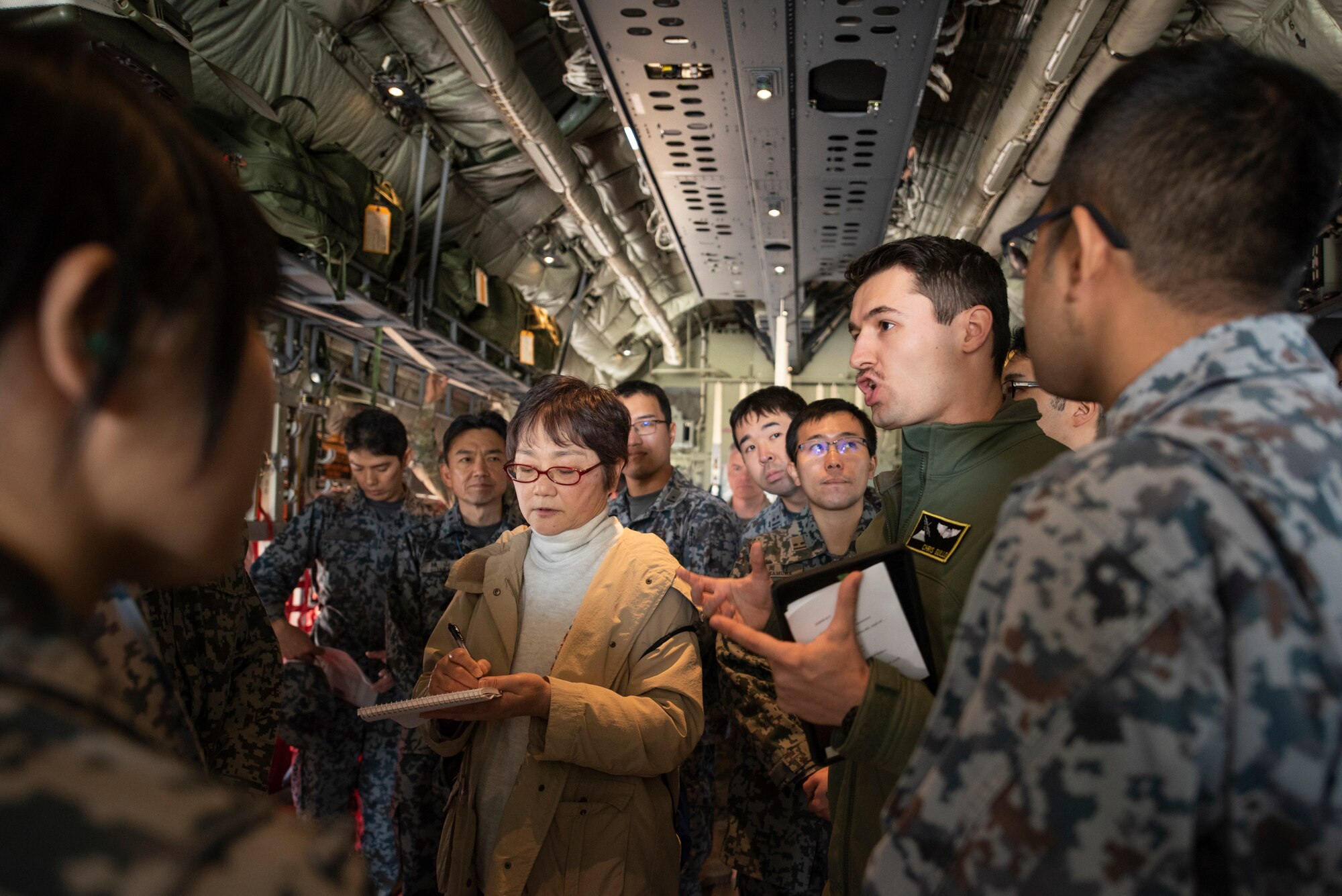 1st Lt. Christopher Gull, 36th Airlift Squadron C-130J Super Hercules pilot and standards and evaluations officer, explains the capabilities of a C-130J to Japanese Air Self-Defense Force Lieutenants during a basic maintenance officer tour at Yokota Air Base, Japan, Nov. 21, 2019