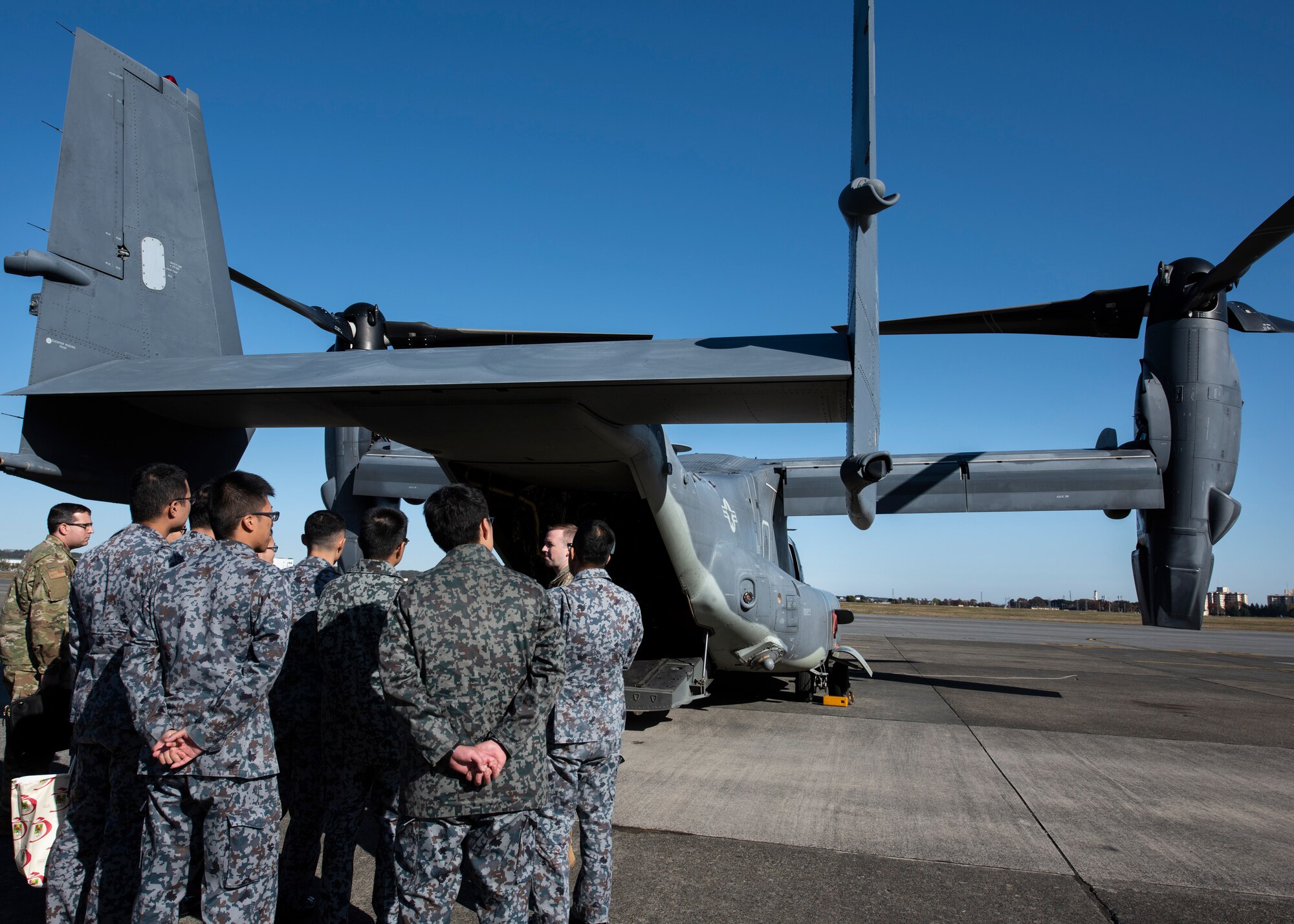 Japanese Air Self-Defense Force Lieutenants tour a CV-22 Osprey during a basic maintenance officer tour at Yokota Air Base, Japan, Nov. 21, 2019.