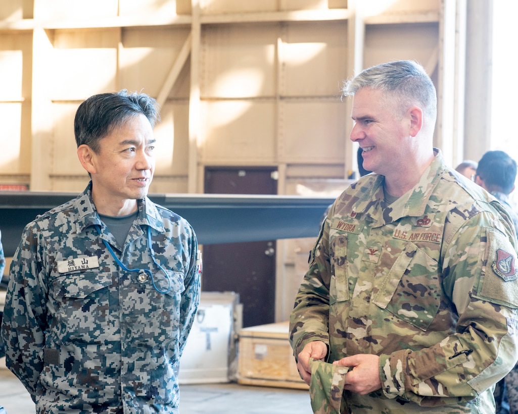 Col. Todd Wydra, 374th Maintenance Group commander, right, talks with Japan Air Self-Defense Force Maj.Gen. Kenichiro Hiyama, First Technical School commandant at Hamamatsu Air Base, Japan, left, during a basic maintenance officer tour at Yokota Air Base, Japan, Nov. 21, 2019