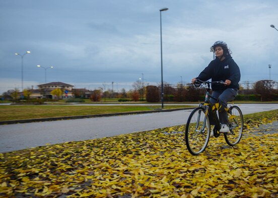 U.S. Airman Ivana Bustamante, 31st Maintenance Squadron aerospace ground equipment apprentice, rides a bike at Aviano Air Base, Italy, Nov. 24, 2019. Bicycling is a great workout because it uses all of the major muscle groups as someone pedals. (U.S. Air Force photo by Airman Thomas S. Keisler IV)