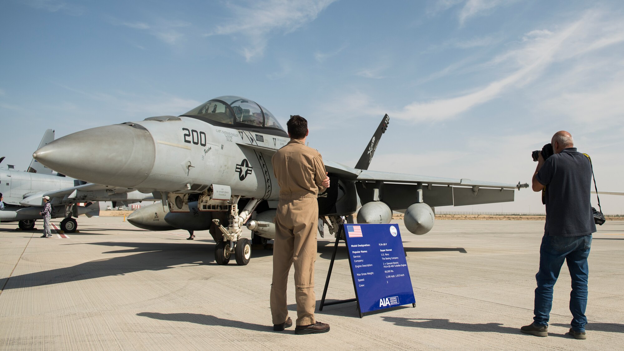 A spectator, right, photographs a U.S. Navy F/A-18E Super Hornet at the Dubai Airshow, United Arab Emirates, Nov. 17, 2019.