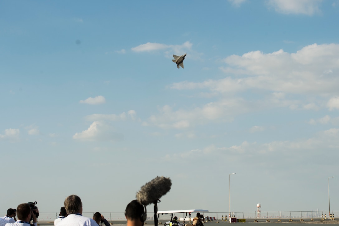 Spectators look on as a U.S. Air Force F-22 Raptor performs an aerial demonstration at the Dubai Airshow, Nov. 17, 2019.