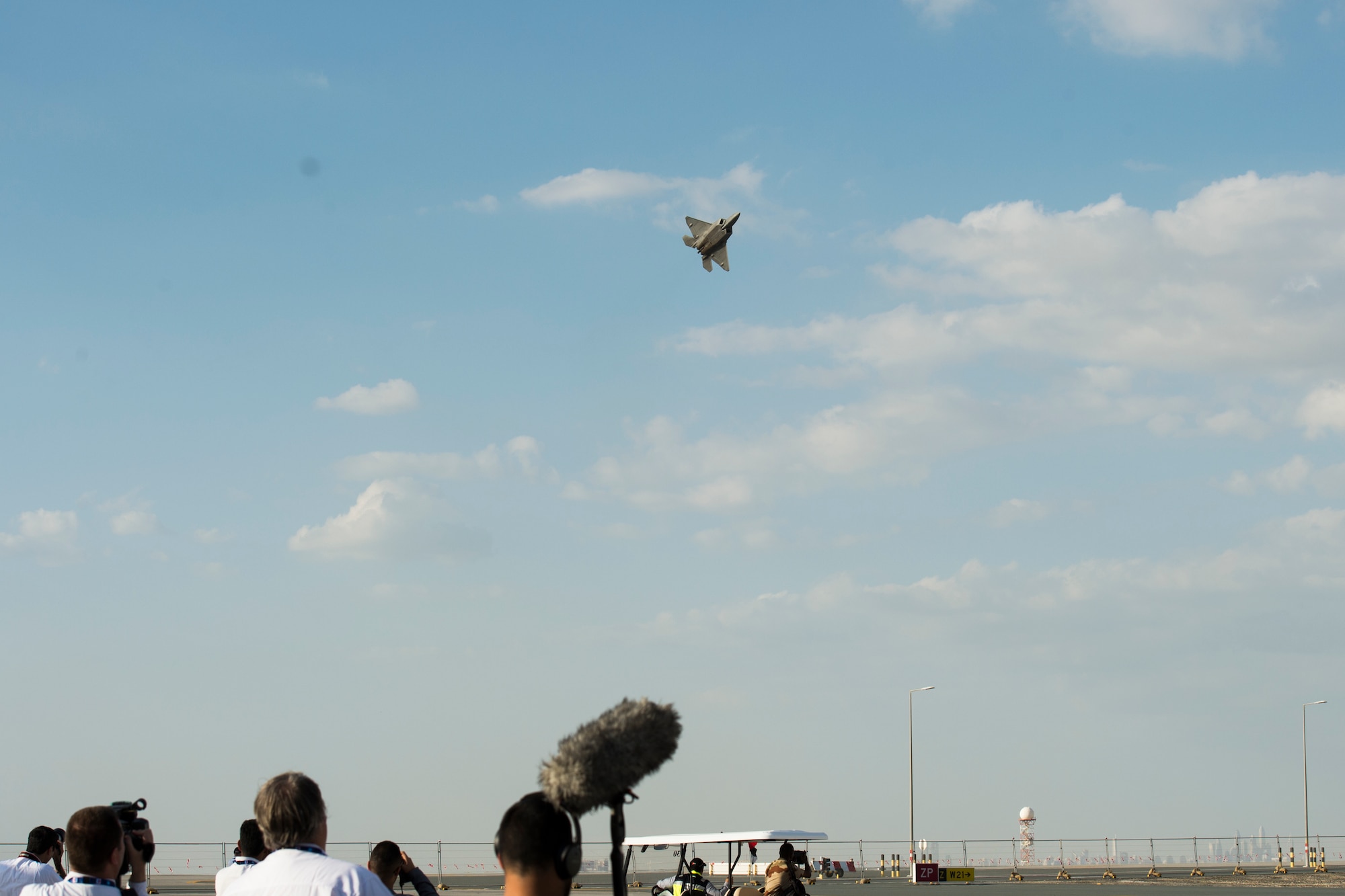Spectators look on as a U.S. Air Force F-22 Raptor performs an aerial demonstration at the Dubai Airshow, Nov. 17, 2019.
