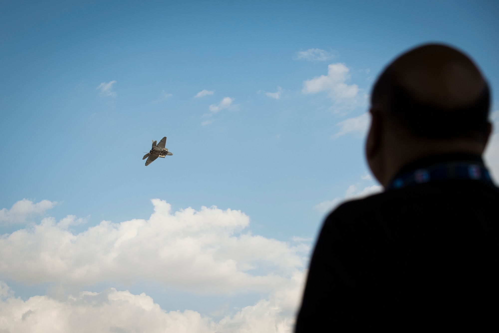 Spectators look on as a U.S. Air Force F-22 Raptor performs an aerial demonstration at the Dubai Airshow, Nov. 17, 2019.
