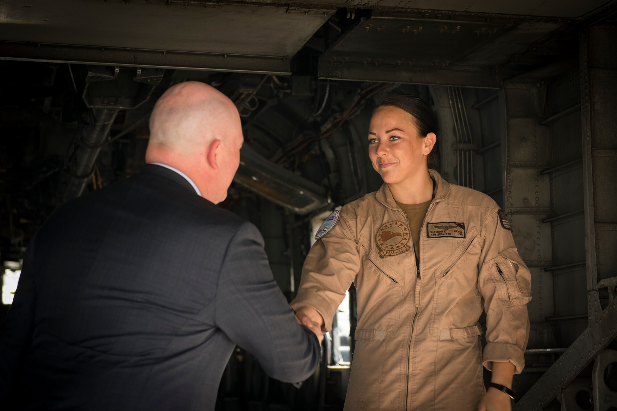 R. Clarke Cooper, left, Assistant Secretary of State for Political-Military Affairs, converses with U.S. Navy AWS2 (NAC/AW) Shannon Hayes, an MH-53E Sea Dragon crew chief with the “Blackhawks” of Helicopter Mine Countermeasures Squadron (HM) 15, inside a Sea Dragon at the Dubai Airshow, United Arab Emirates, Nov. 17, 2019.