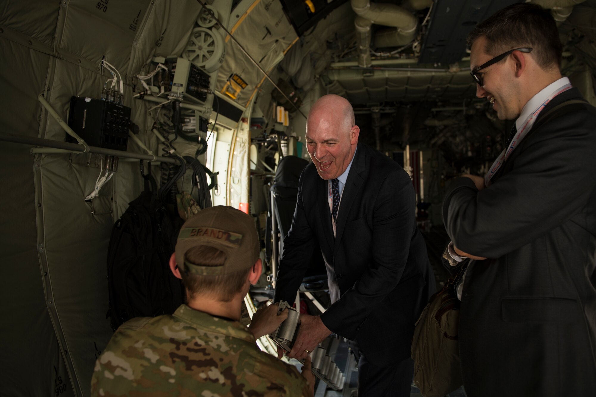 R. Clarke Cooper, right, Assistant Secretary of State for Political-Military Affairs, converses with U.S. Air Force Senior Airman Nolan Brandt, a loadmaster with the 774th Expeditionary Airlift Squadron, inside a C-130J Super Hercules at the Dubai Airshow, United Arab Emirates, Nov. 17, 2019.