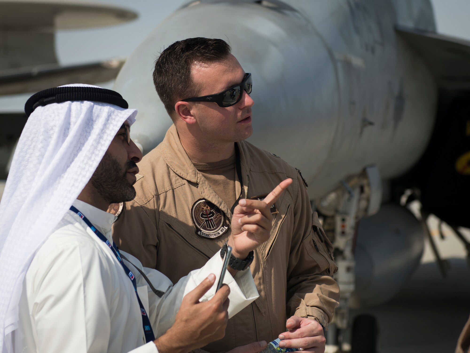 U.S. Navy Lt. Blake Rademaker, center, an F/A-18E Super Hornet pilot with the "Sidewinders" of Strike Fighter Squadron (VFA) 86, discusses U.S. Navy military aircraft capabilities at the Dubai Airshow, United Arab Emirates, Nov. 18, 2019.