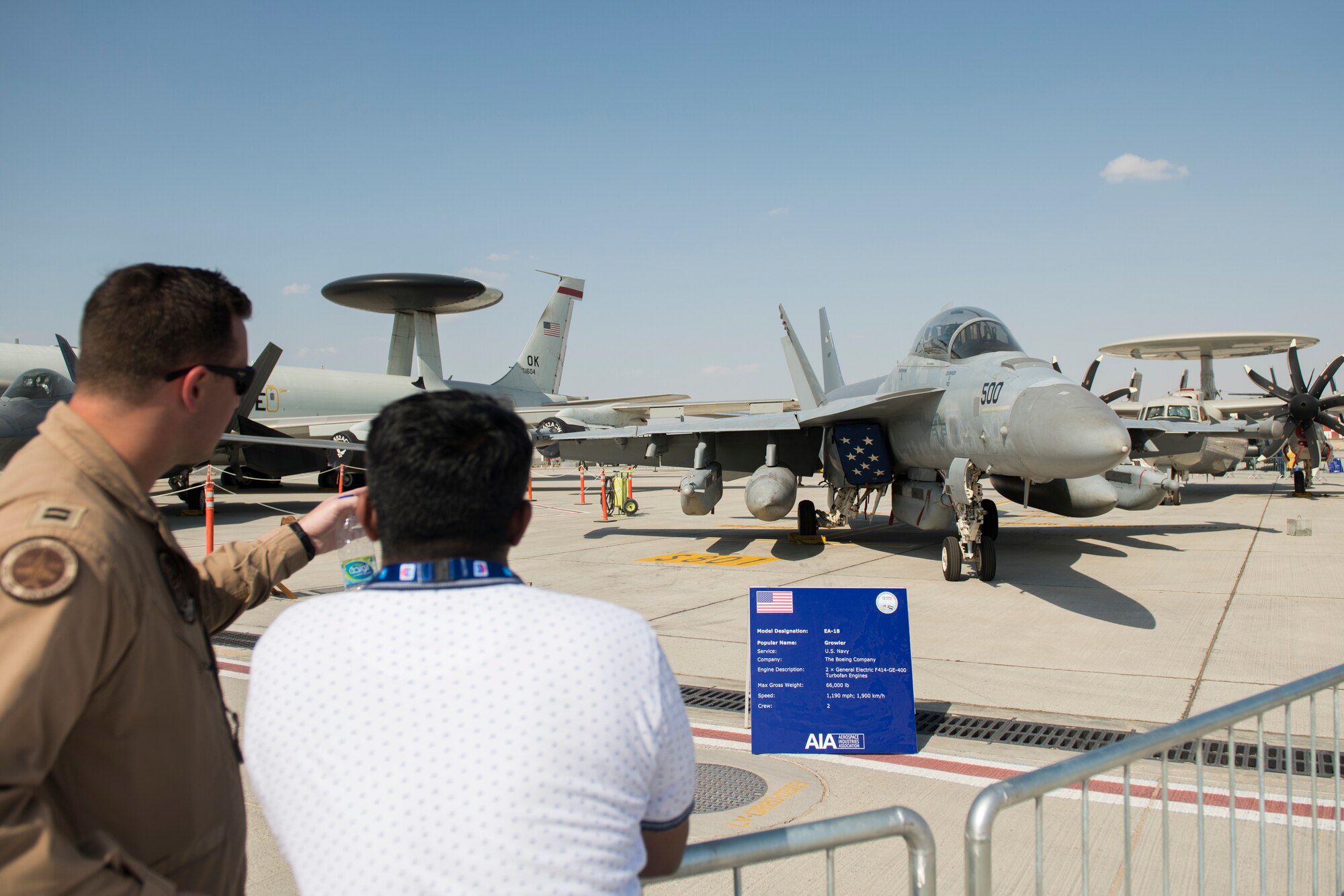 U.S. Navy Lt. Blake Rademaker, left, an F/A-18E Super Hornet pilot with the "Sidewinders" of Strike Fighter Squadron (VFA) 86, discusses U.S. Navy EA-18G Growler capabilities at the Dubai Airshow, United Arab Emirates, Nov. 18, 2019.