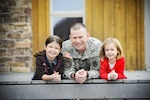 In this photo from November 2012, Ohio Army National Guard Capt. Chris Brandt with his daughters, Katy (left, now 15) and Riley (now 12).