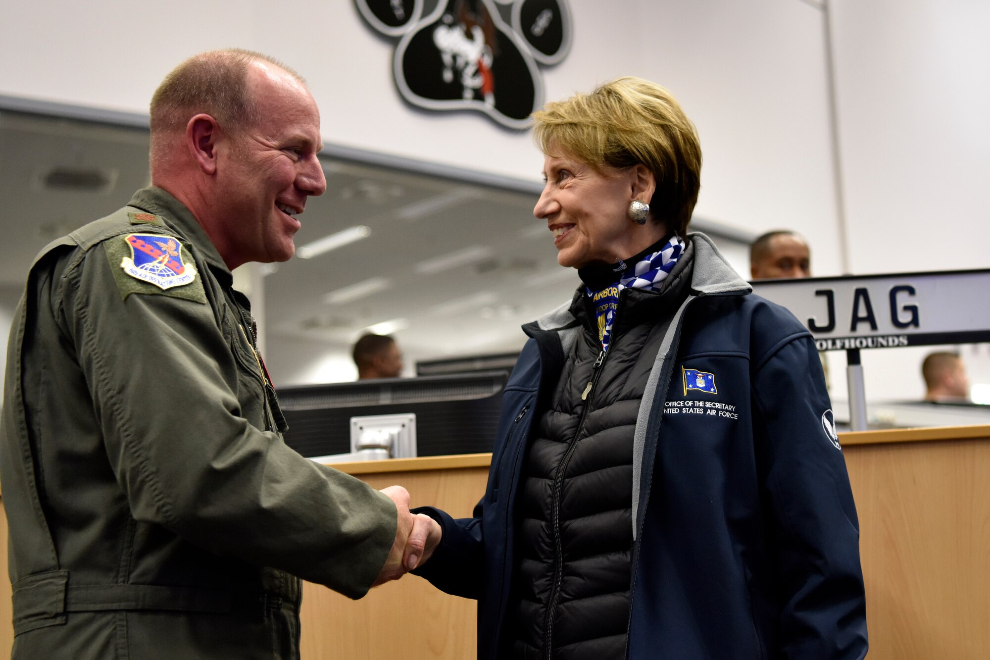 U.S. Air Force Maj. Kevin Edwards, U.S. Air Forces in Europe and Air Forces Africa joint interface control officer, receives a coin from Secretary of the Air Force Barbara M. Barrett during a tour of the 603rd Air and Space Operations Center at Ramstein Air Base, Germany, Nov. 22, 2019.