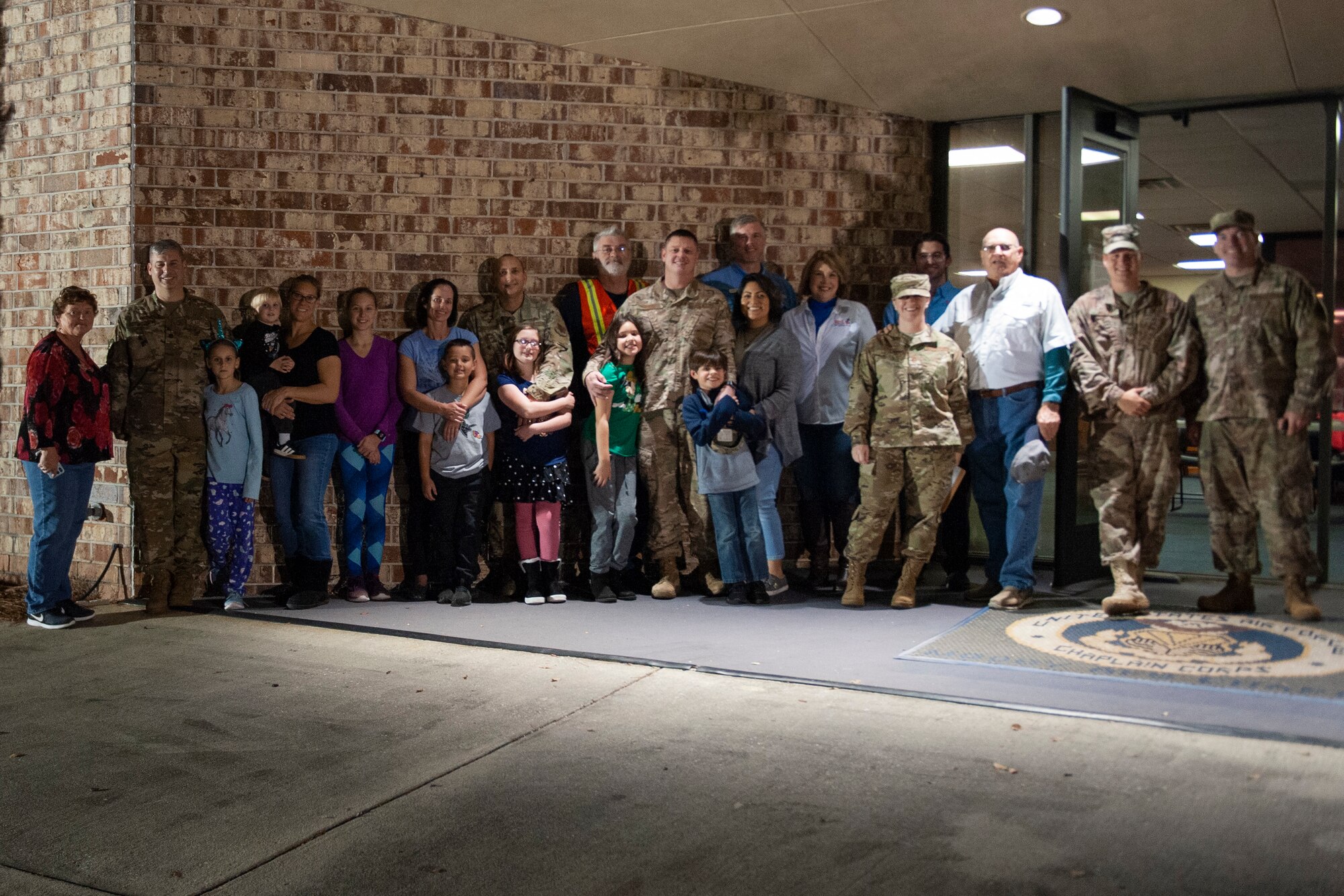 A photo of volunteers posing for a photo during a Thanksgiving dinner.