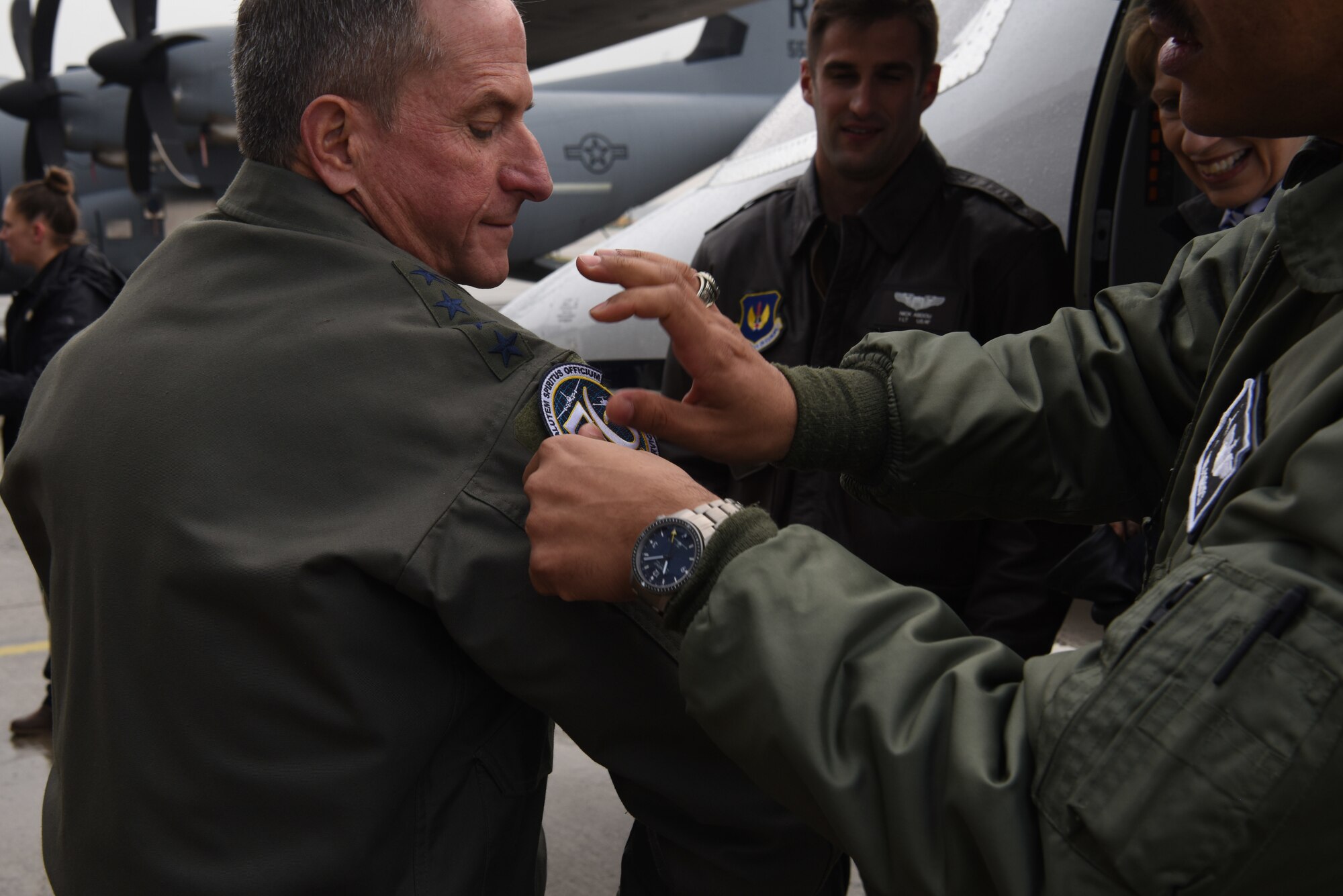 A member of the 86th Aeromedical Evacuation Squadron places a squadron patch on Air Force Chief of Staff Gen. David L. Goldfein after a capabilities brief on Ramstein Air Base, Germany, Nov. 22, 2019.