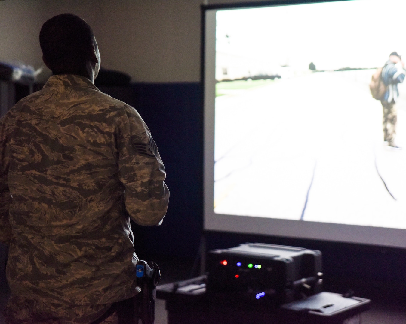 A 189th Security Forces Squadron defender accomplishes use-of-force training on a simulator designed to supplement annual training. The simulator offers 27 Guard-specific scenarios.