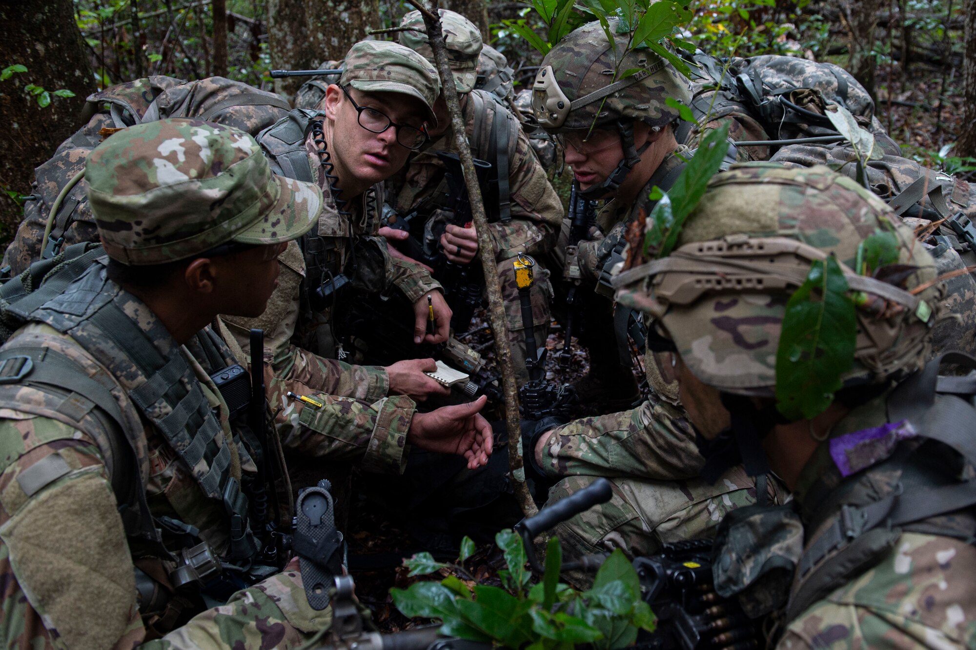 A photo of squad leaders discussing strategy during an Air Force Ranger Assessment Course
