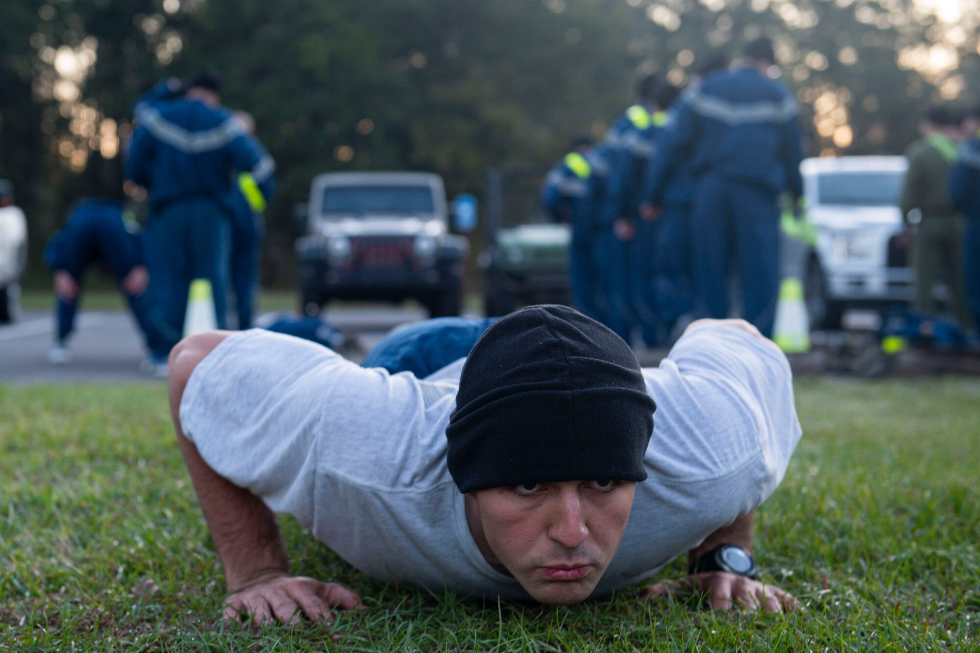 A photo of an Air Force Ranger Assessment Course student performing a push-up