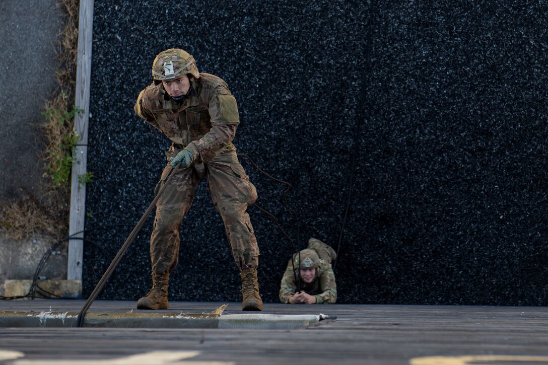 A photo of an Air Force Ranger Assessment Course student rappelling from a tower