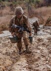 A recruit with Hotel Company, 2nd Recruit Training Battalion, carries an ammunition can up a hill during a crucible event at Marine Corps Base Camp Pendleton, California, Nov. 20, 2019.